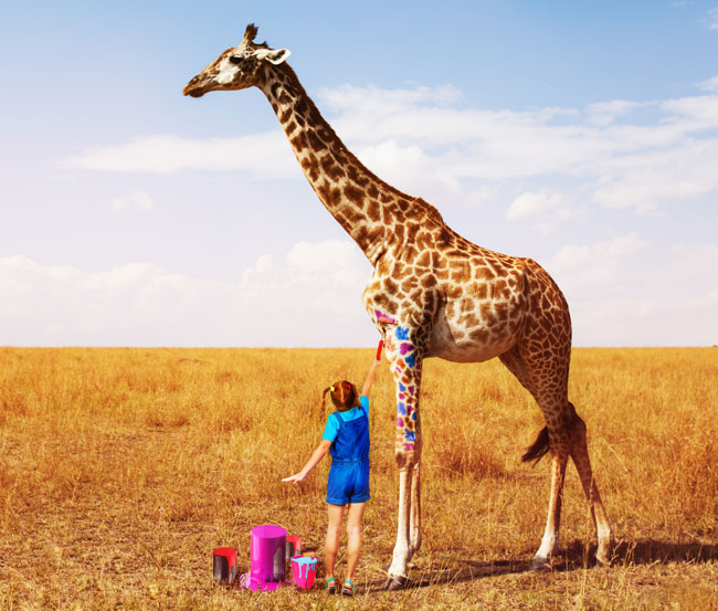 little girl painting giraffe