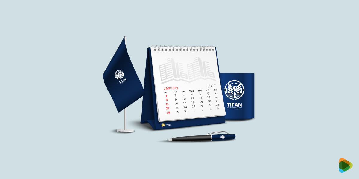 Titan Security Group Branded Stationery Mockup Titan Security Group branding on desk items including calendar, flag, mug, and pen.