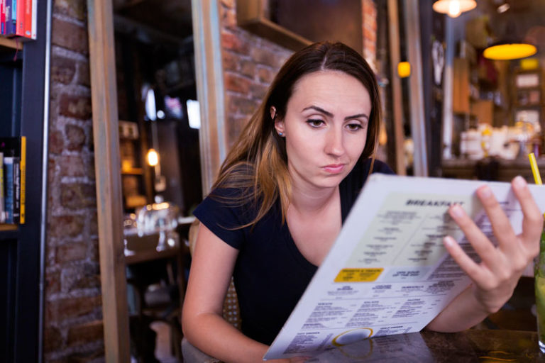woman looking at menu
